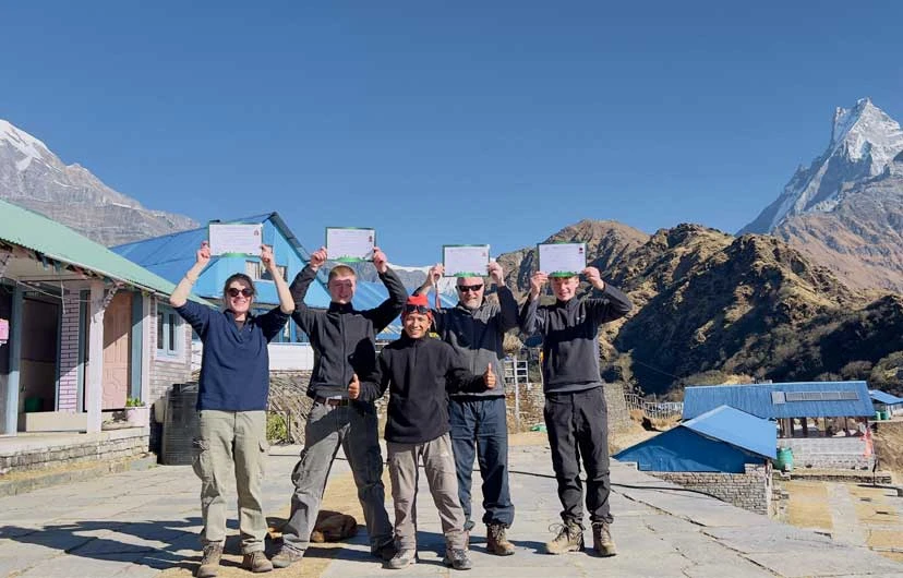 Trekkers celebrating and enjoying their successful arrival at Mardi Himal Base Camp near High Camp during the Mardi Himal Trek 4 days .